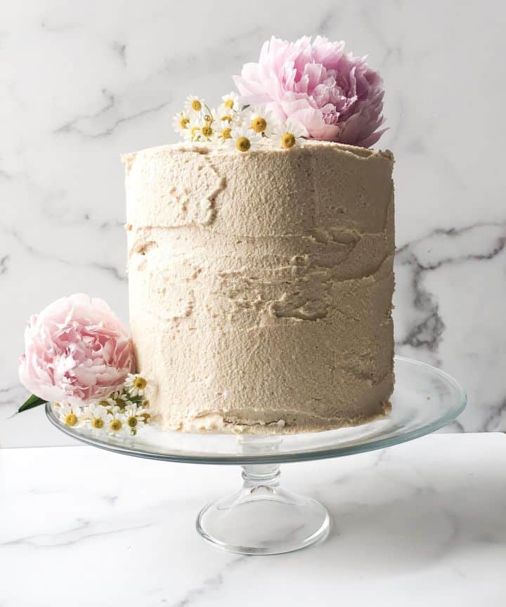 paleo vanilla cake on a clear cake holder