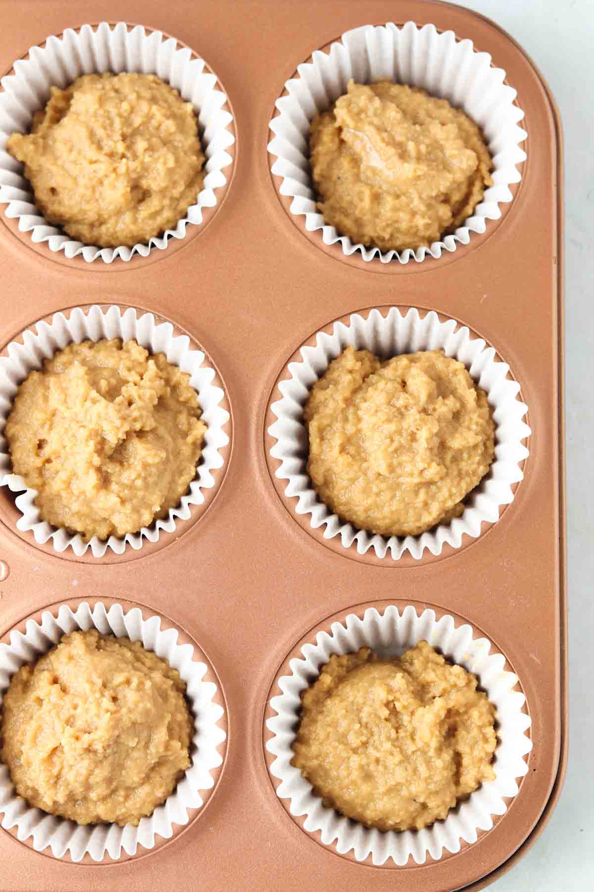 Cupcake batter in a cupcake pan. 