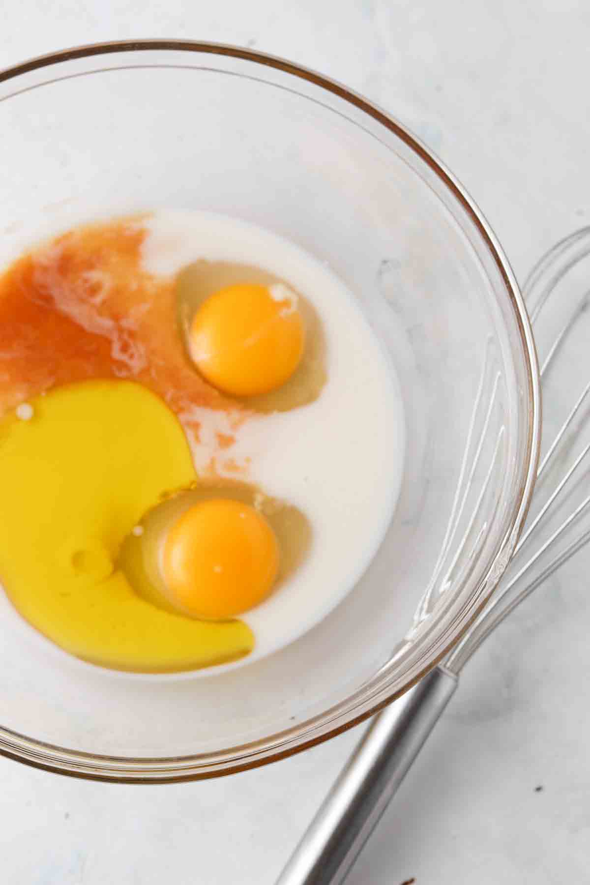 Wet cupcake ingredients in a glass mixing bowl.