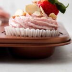 Strawberry cupcakes in a muffin pan.