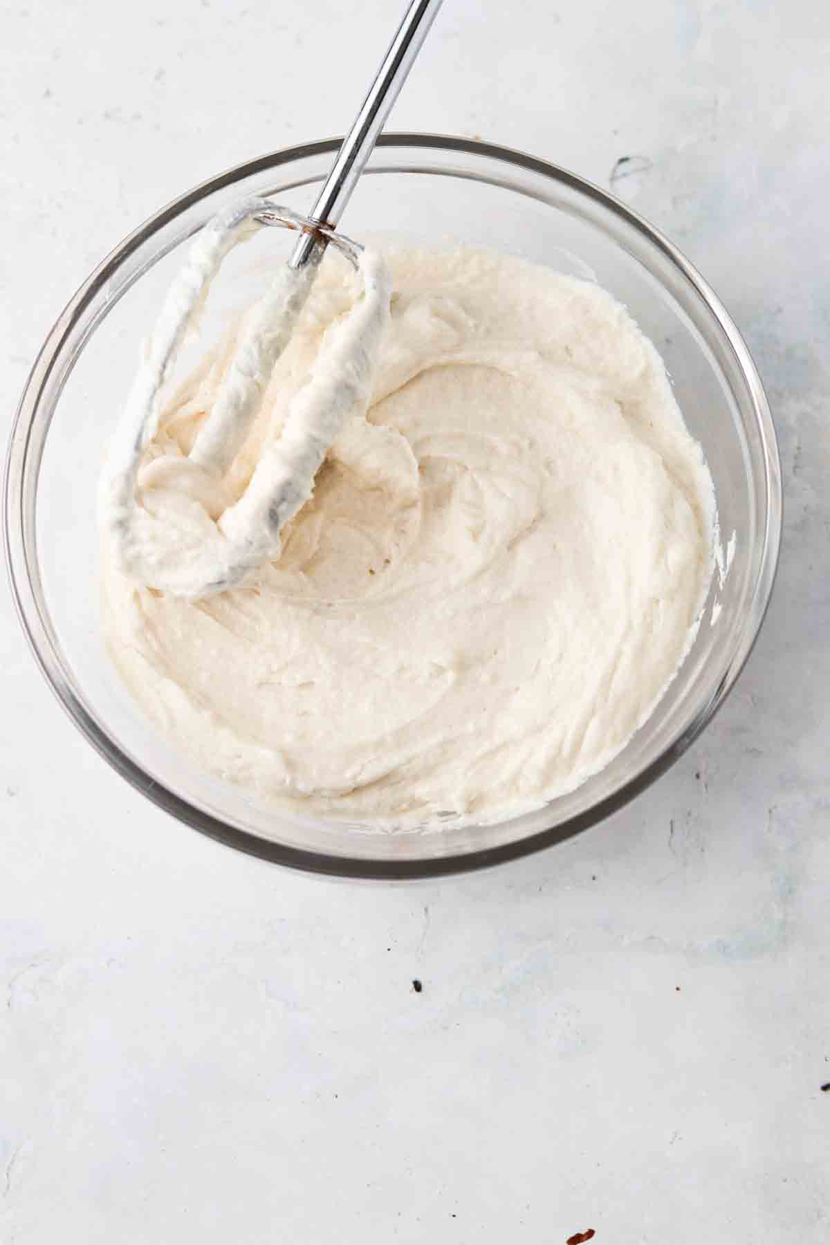 Strawberry cupcake frosting in a bowl.