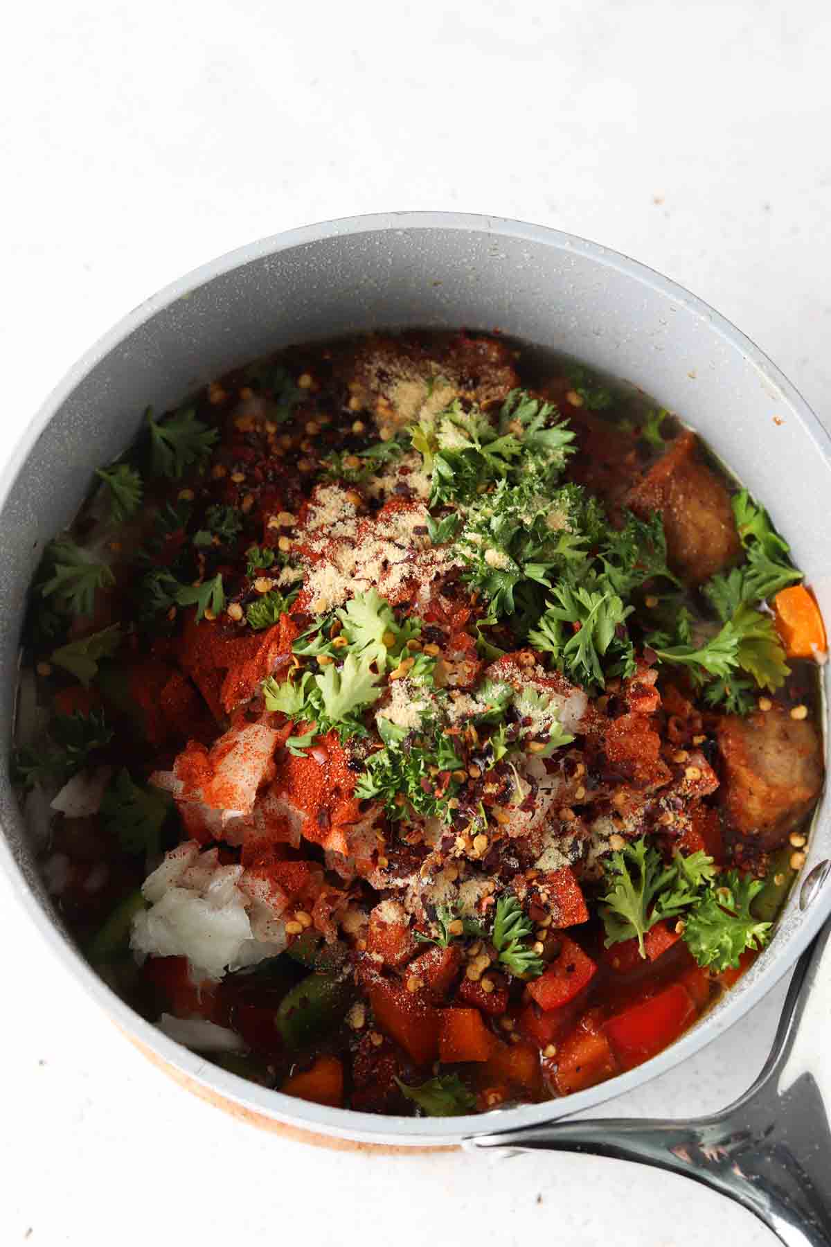 All paella ingredients mixed into the frying pan.