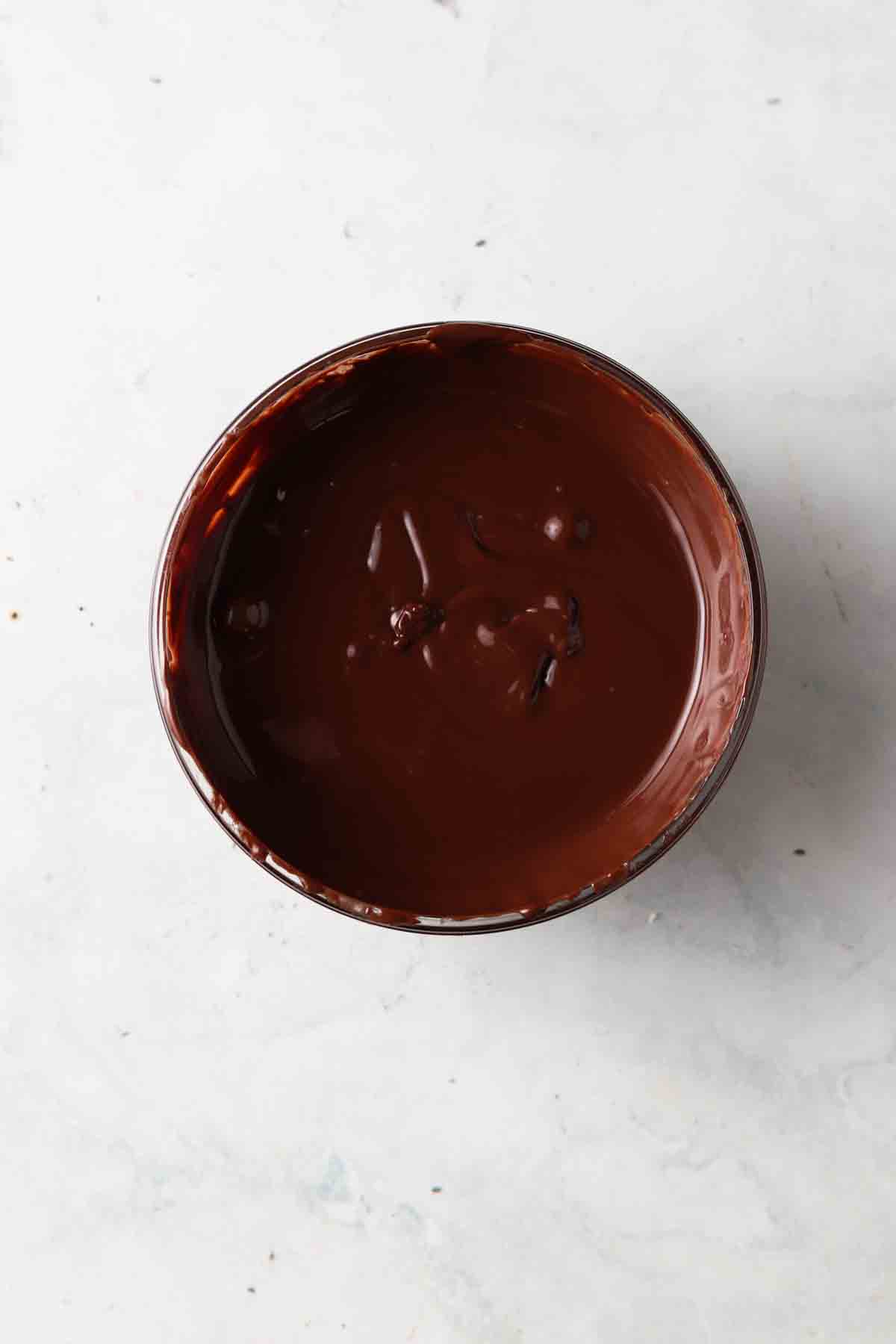 Melted chocolate in a small glass bowl.