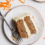 slice of carrot cake on a plate with a fork