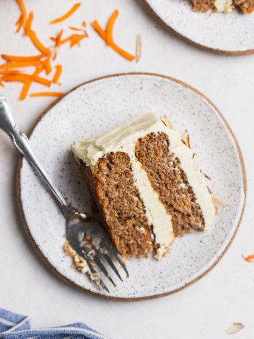 slice of carrot cake on a plate with a fork