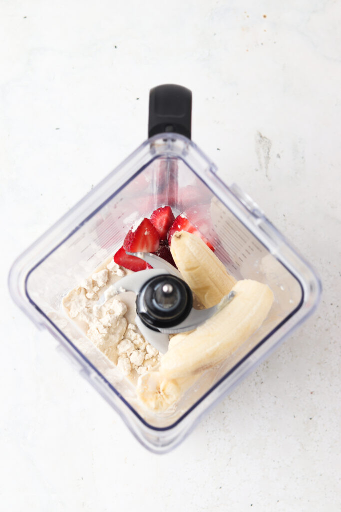 strawberry smoothie ingredients in a food processor