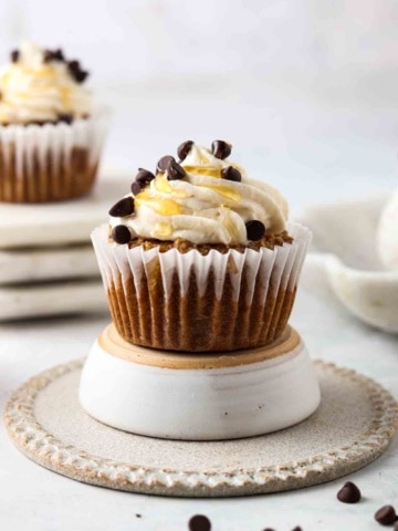 close up shot of a gluten free cupcake with vanilla frosting on top