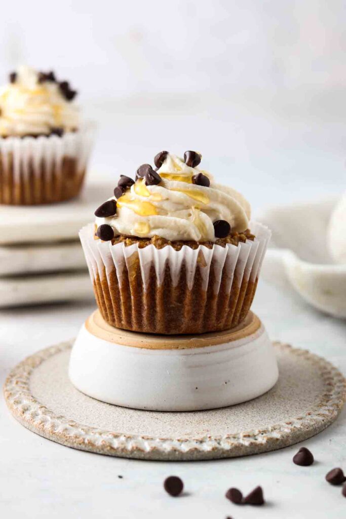 close up shot of a gluten free cupcake with vanilla frosting on top