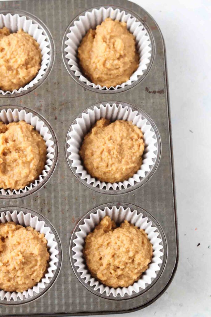 raw cupcake batter in muffin pans