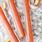 freeze pops with peaches laid out on ice cubes