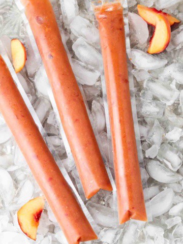 freeze pops with peaches laid out on ice cubes