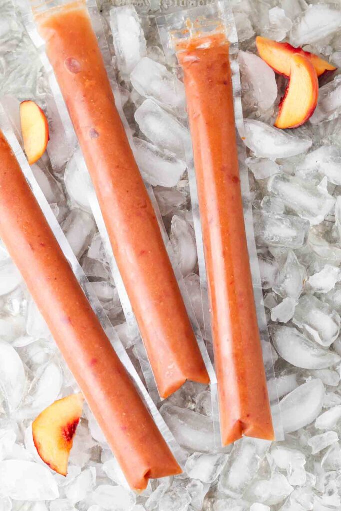 homemade freeze pops 2 freeze pops with peaches laid out on ice cubes