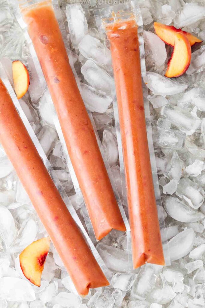 freeze pops with peaches laid out on ice cubes