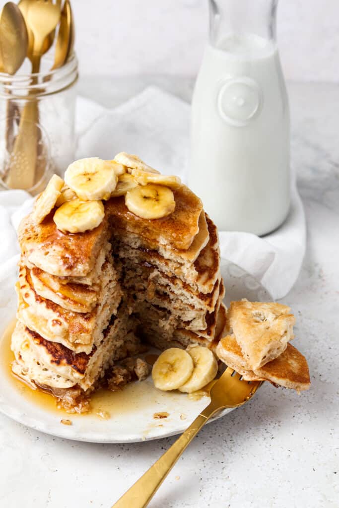 3 ingredient protein pancakes on a plate with a fork and milk