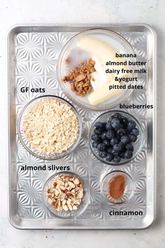 Blueberry Banana Overnight Oats recipe ingredients laid out on a metal pan 