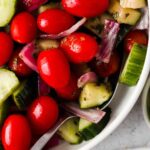 greek salad in a bowl with a spoon