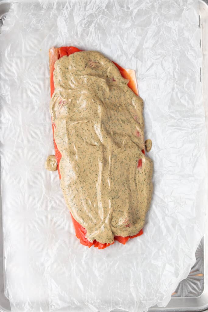 salmon on wax paper being prepped for the oven