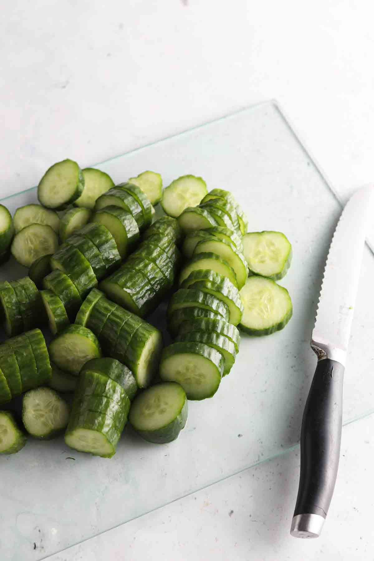 Chopped cucumbers on a cutting board.