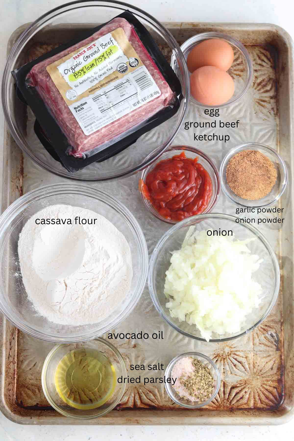 Gluten free meatloaf ingredients laid out on a sheet pan.