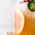 grapefruit juice in a glass with a jalapeno on top