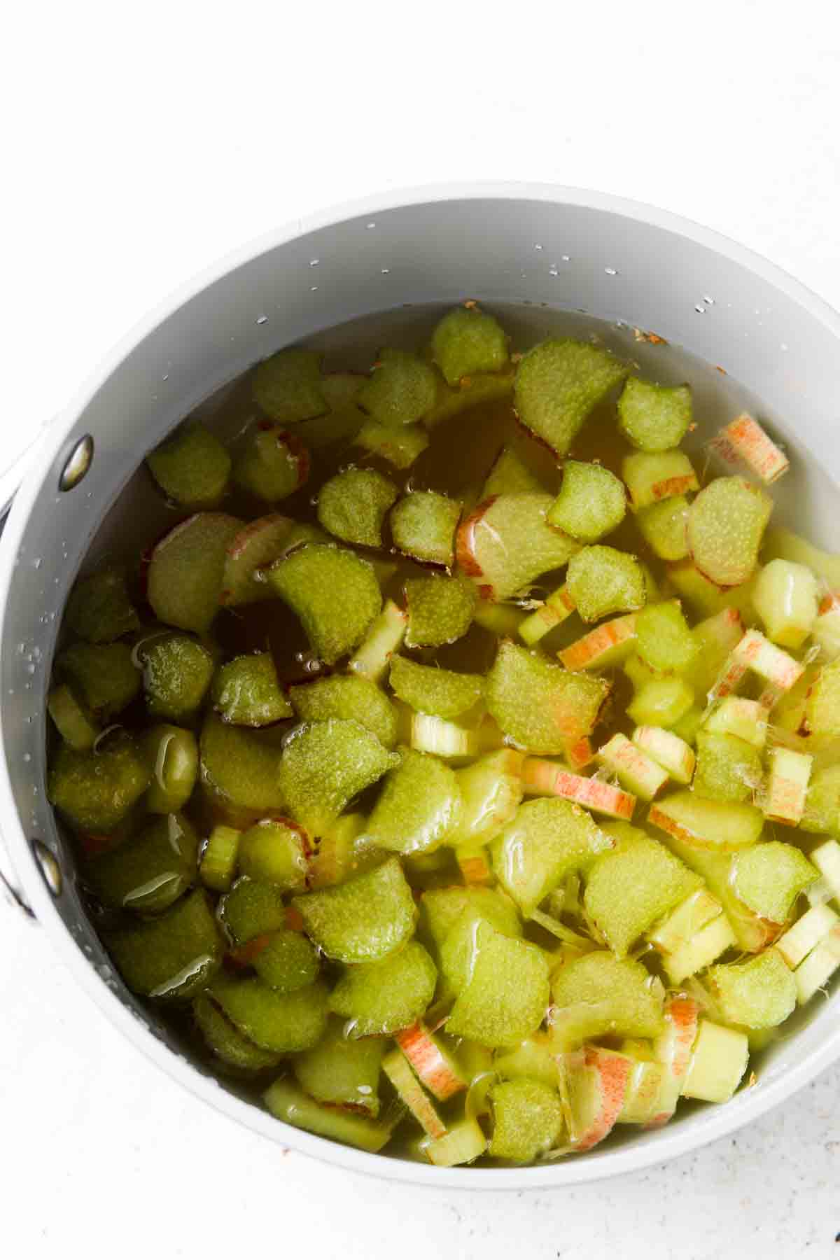 Rhubarb, water, and honey in a pot. 