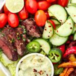 steak salad over greens with peppers and avocado cream dressing