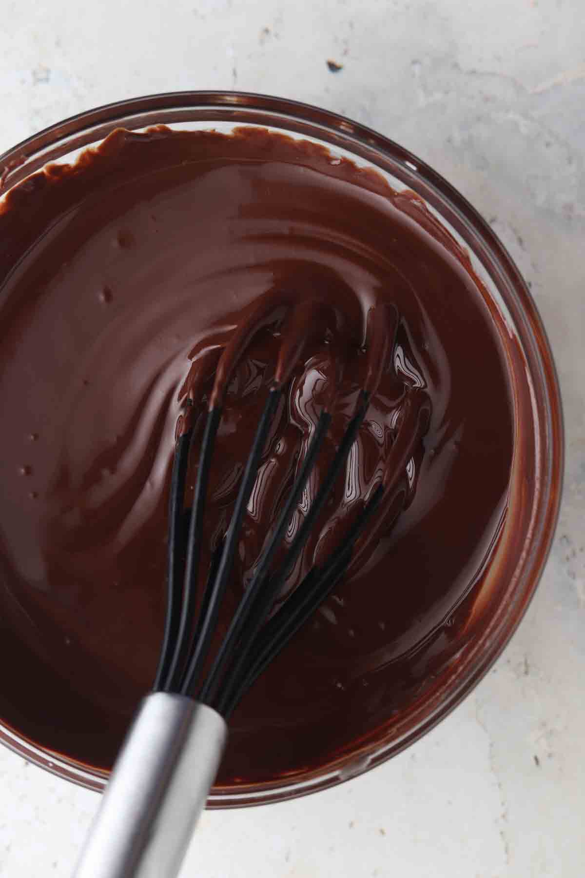 Melted chocolate in a glass bowl.