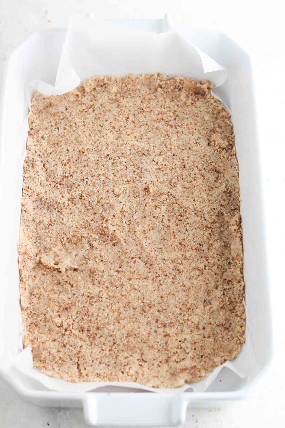 Graham cracker crust laid out in a casserole dish.