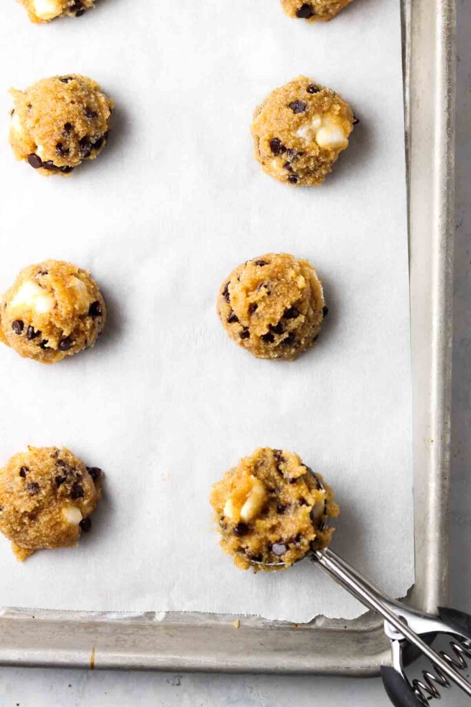 raw cookie dough scooped on a cookie tray