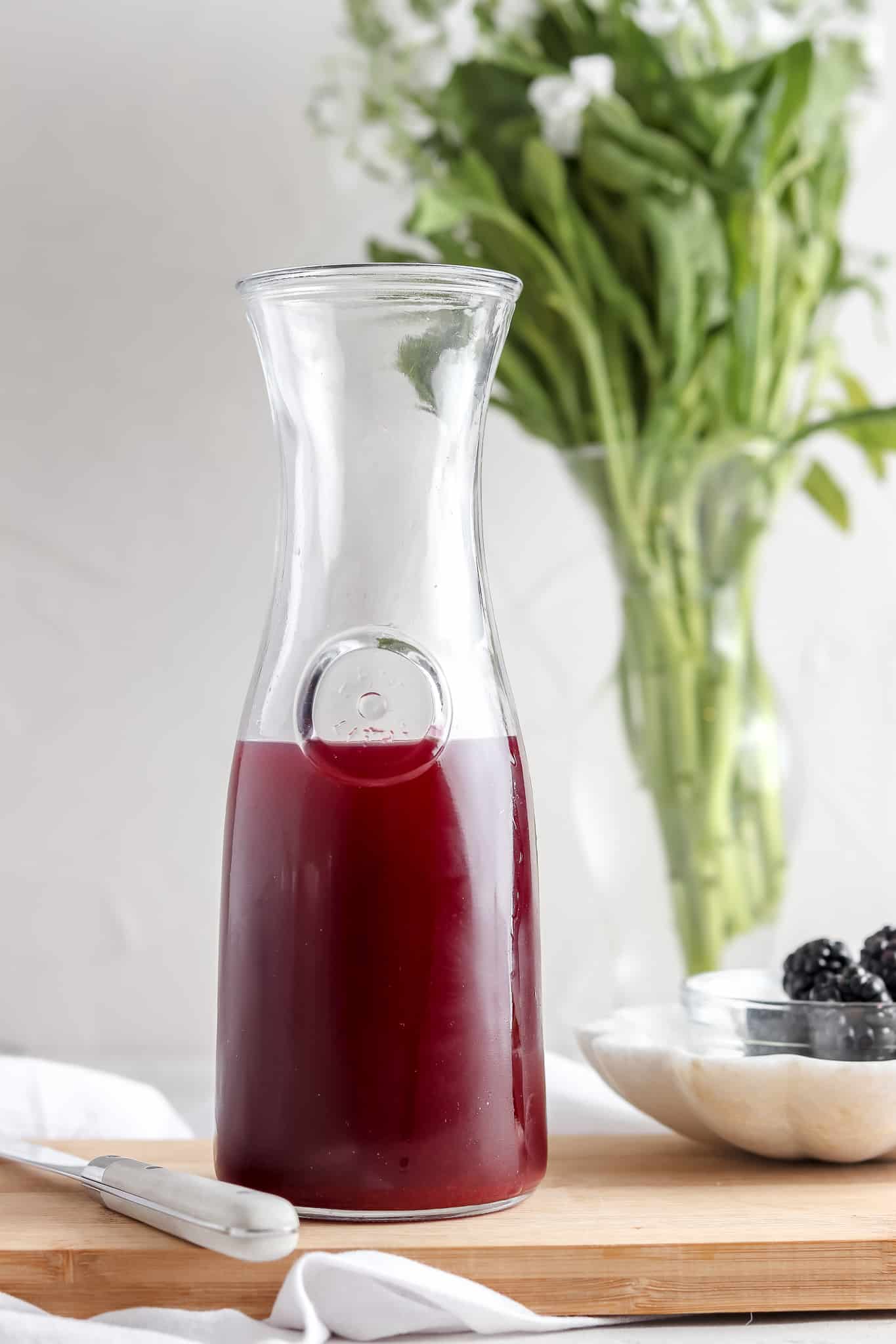 Blackberry simple syrup in a glass jar.