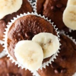 Close up photo of a chocolate chip banana muffin with banana slices on top.