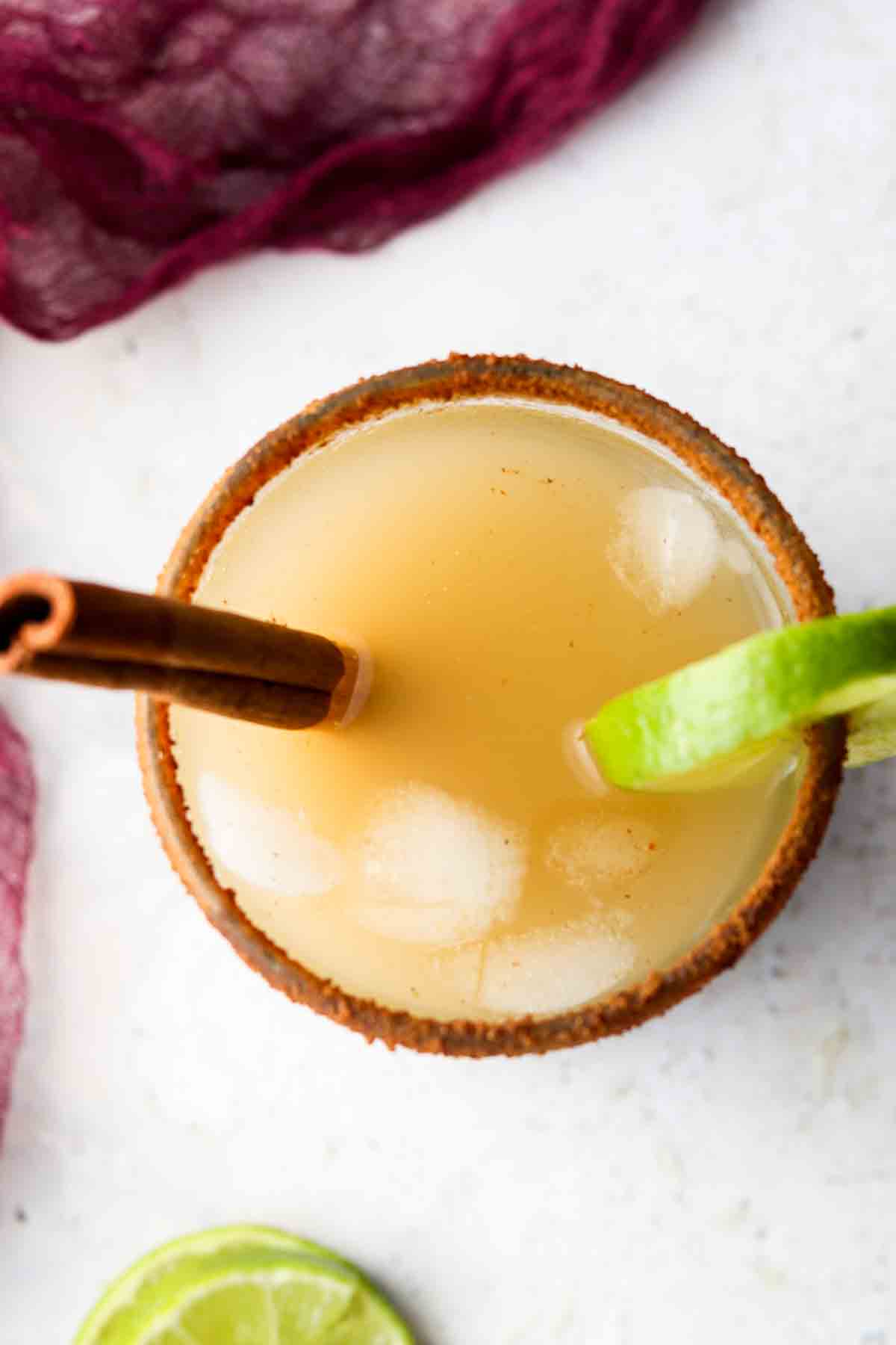 Overhead shot of an apple cider margarita in a cup.