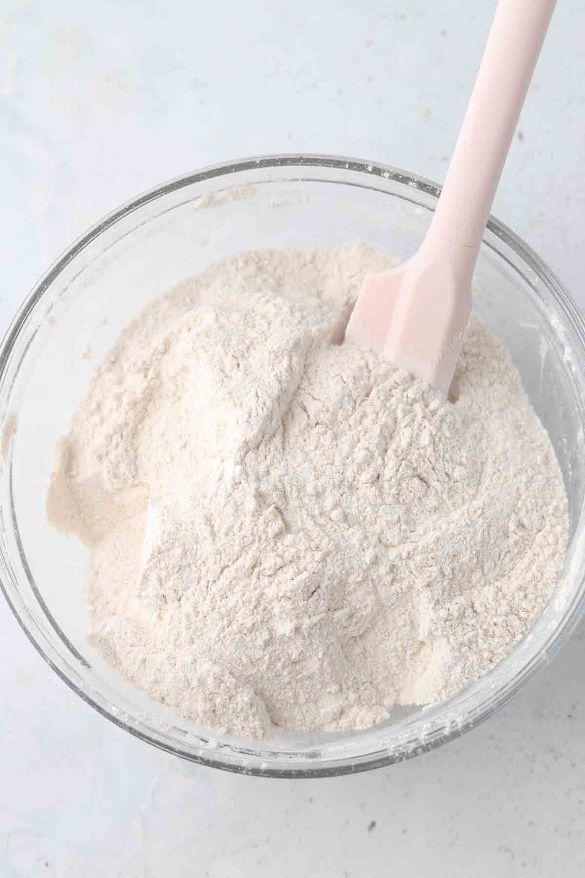 Cassava flour, paprika, onion powder, and garlic powder mixed together in a glass mixing bowl.