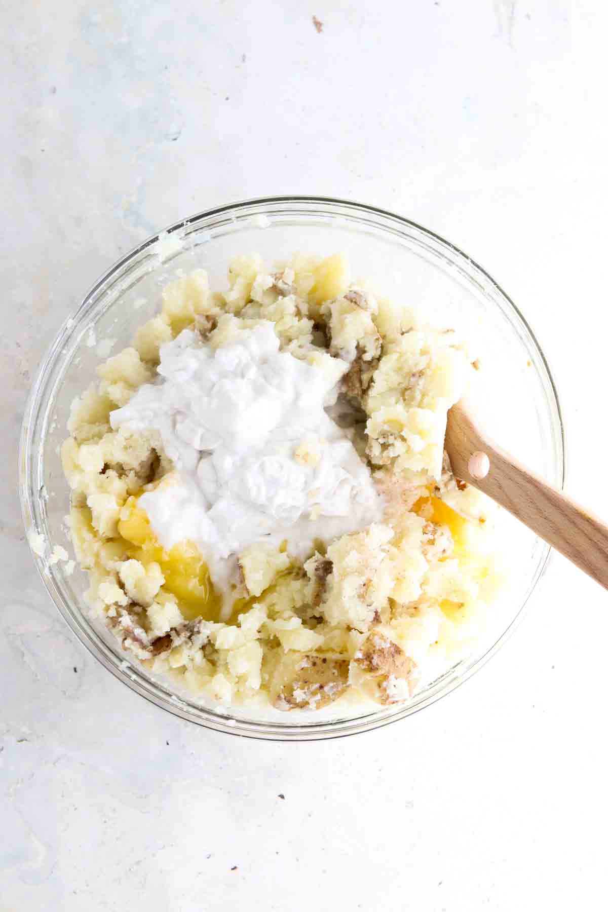 Potatoes, coconut cream, ghee, salt and garlic powder in a bowl.
