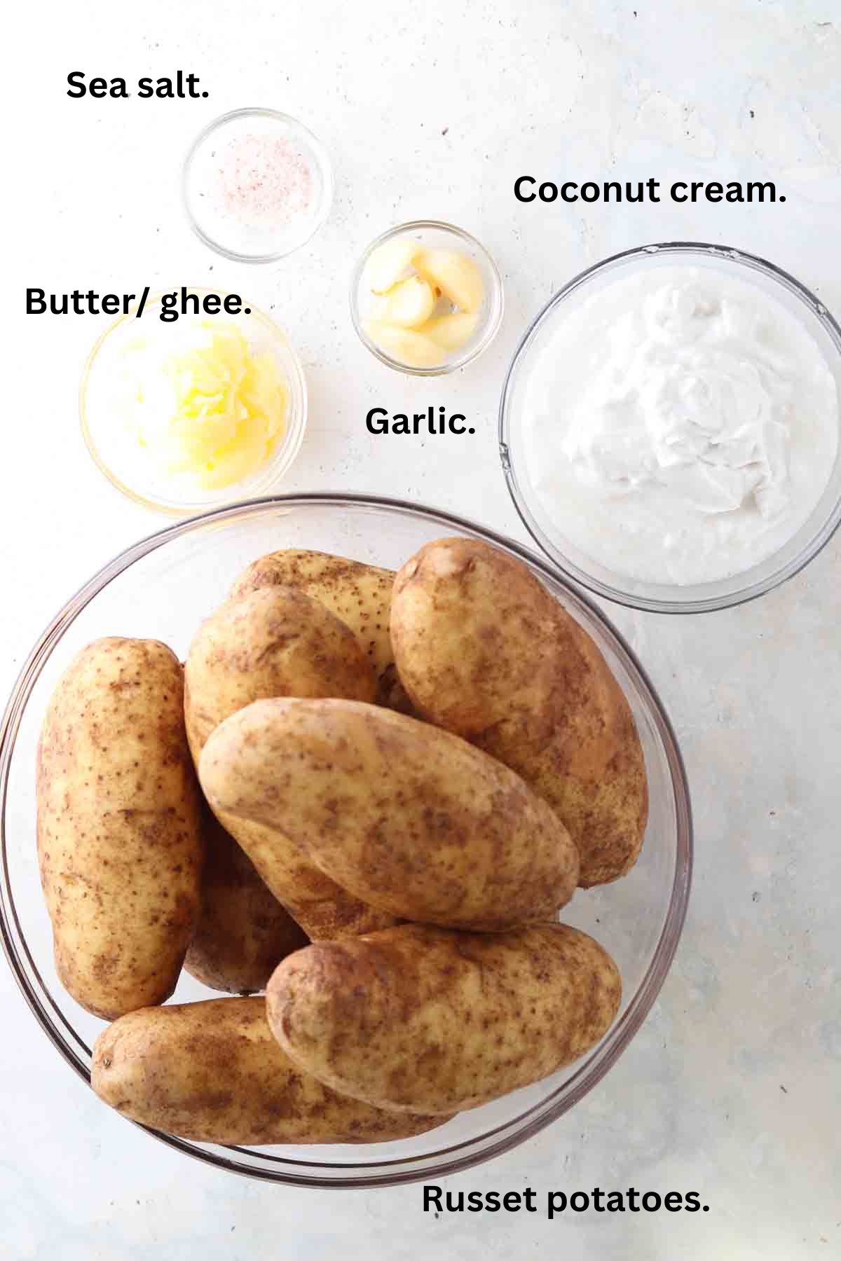 Mashed potatoes ingredients laid out on the counter in small bowls.