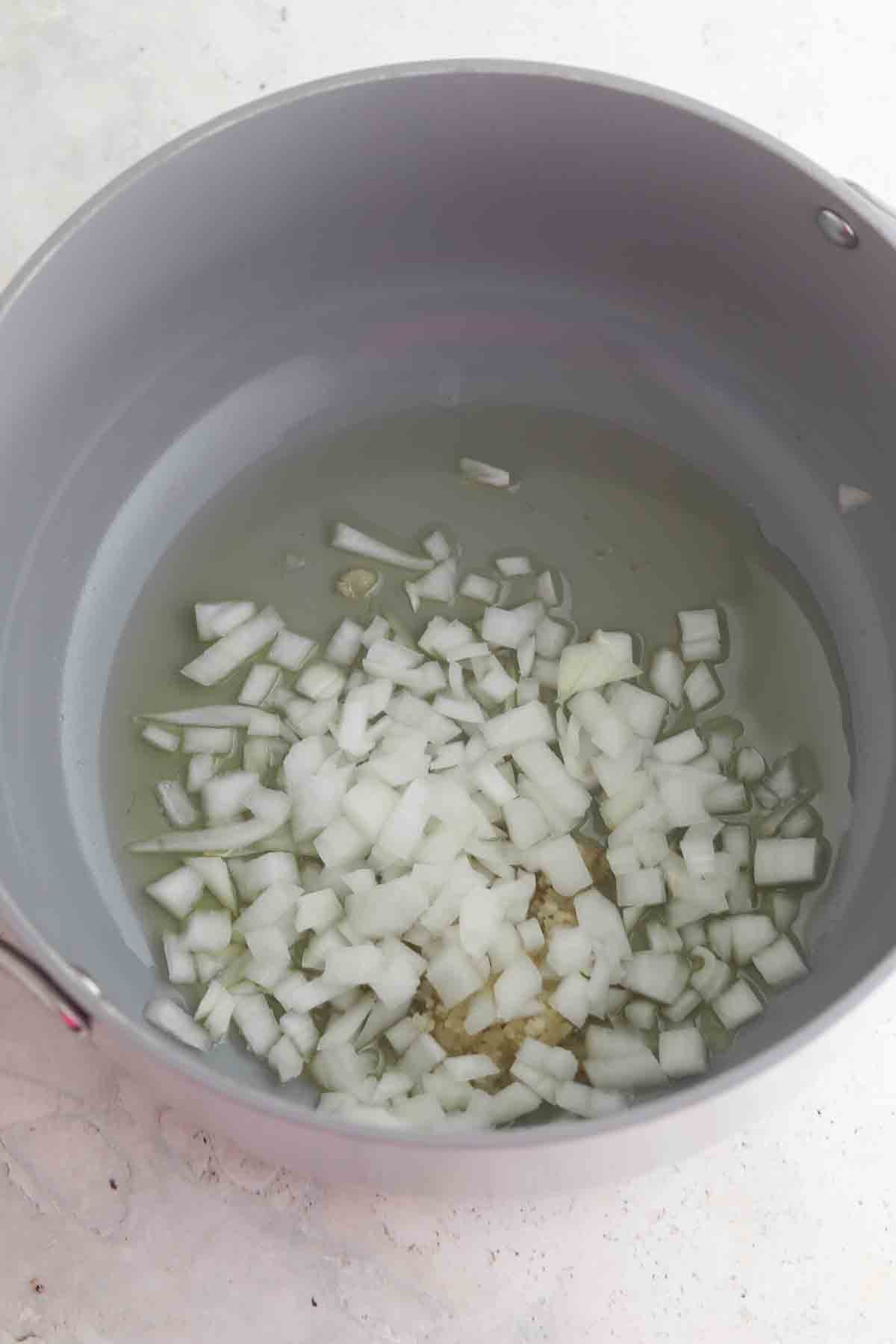 Onions, garlic and oil in a dutch oven.
