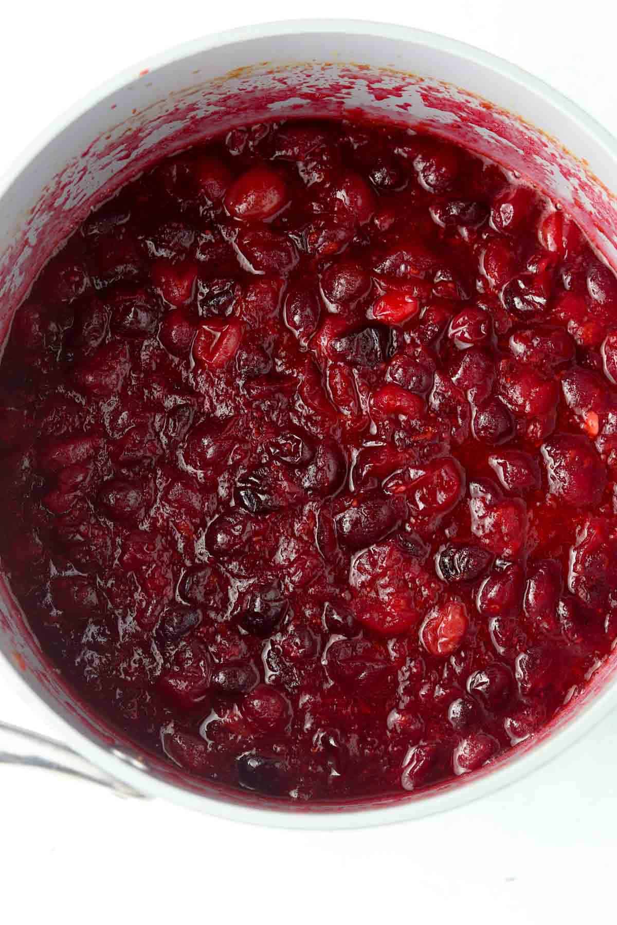 Cooked cranberry sauce in a gray pan.