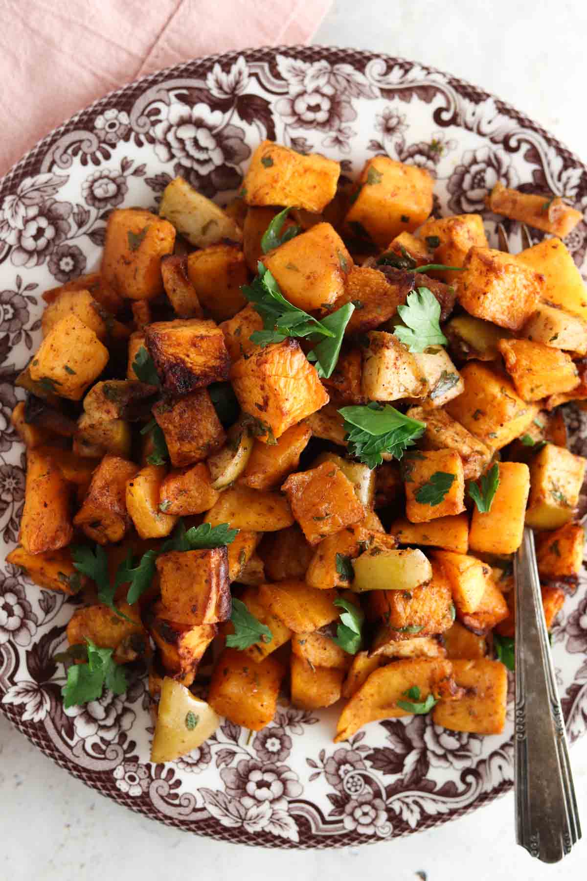 Butternut squash on a brown floral plate.