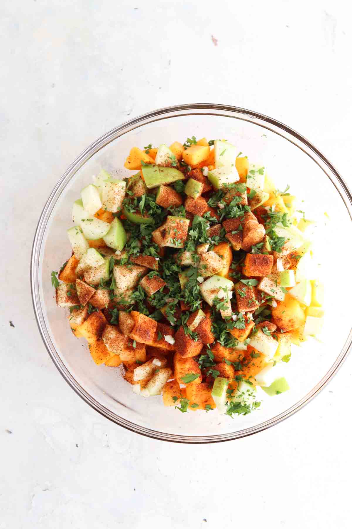 Squash, fresh parsley, coconut sugar, sea salt and chopped apple in a bowl.
