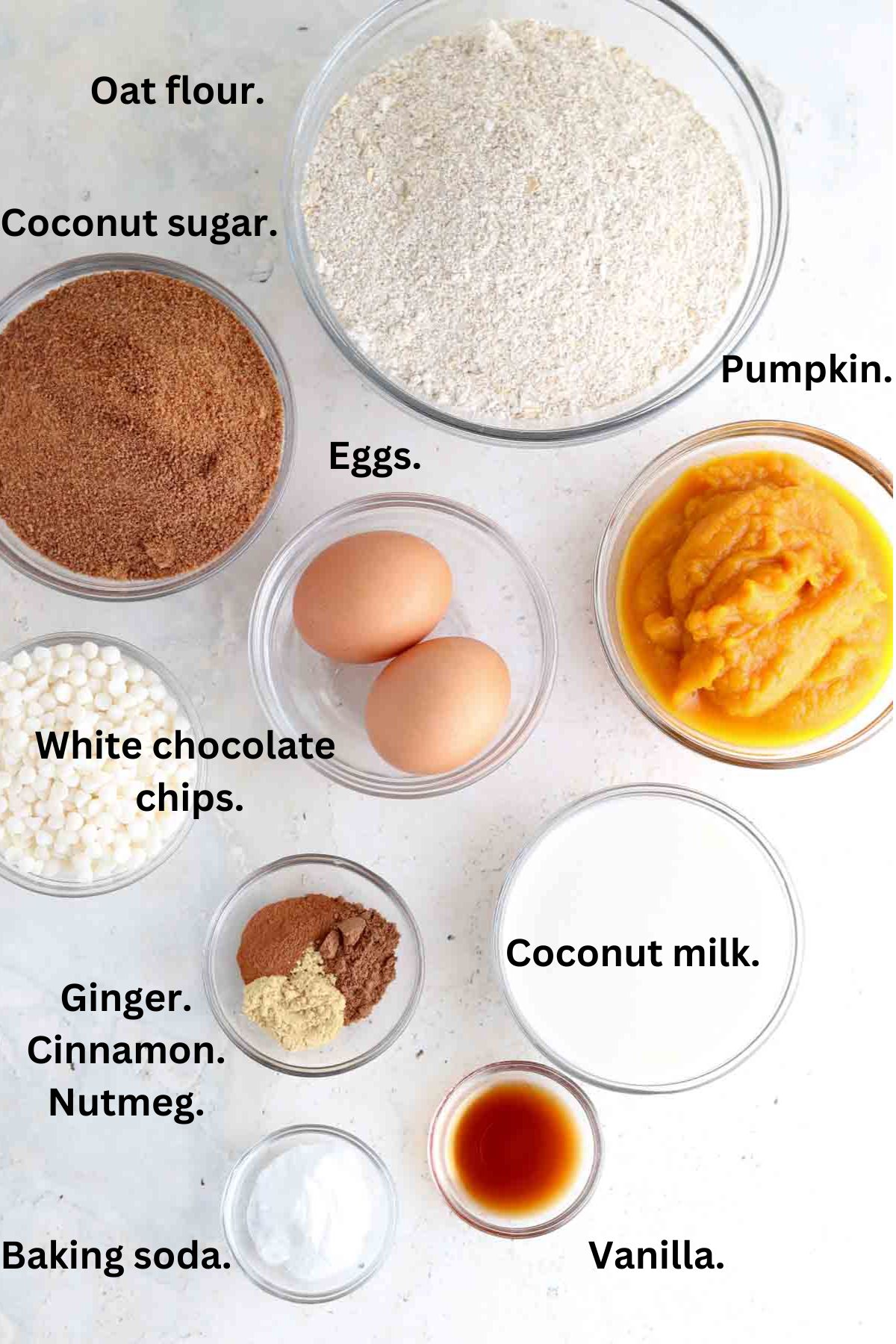 Oat flour pumpkin muffin ingredients laid out in bowls on the counter. 