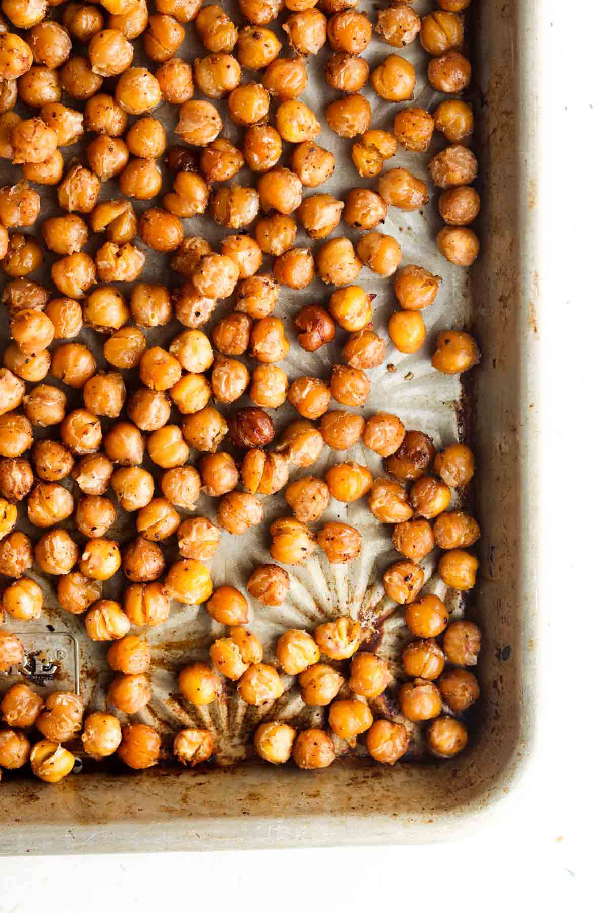 Crispy chickpea croutons on a silver baking sheet.