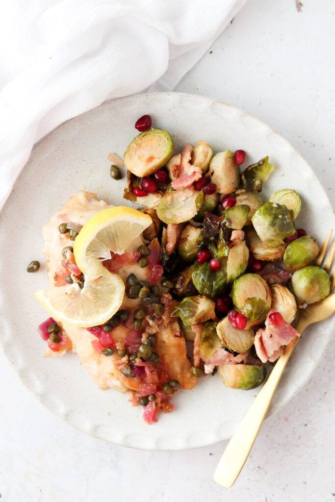 paleo chicken piccata on a plate with gold fork