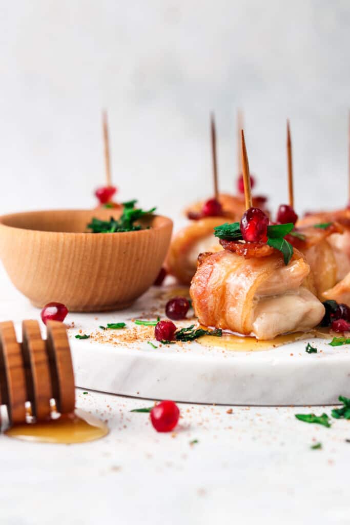 AIP bacon maple chicken bites on a marble board with maple honey drizzled
