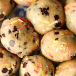 Close up photo of gluten free cookie dough with sprinkles in it rolled into balls.
