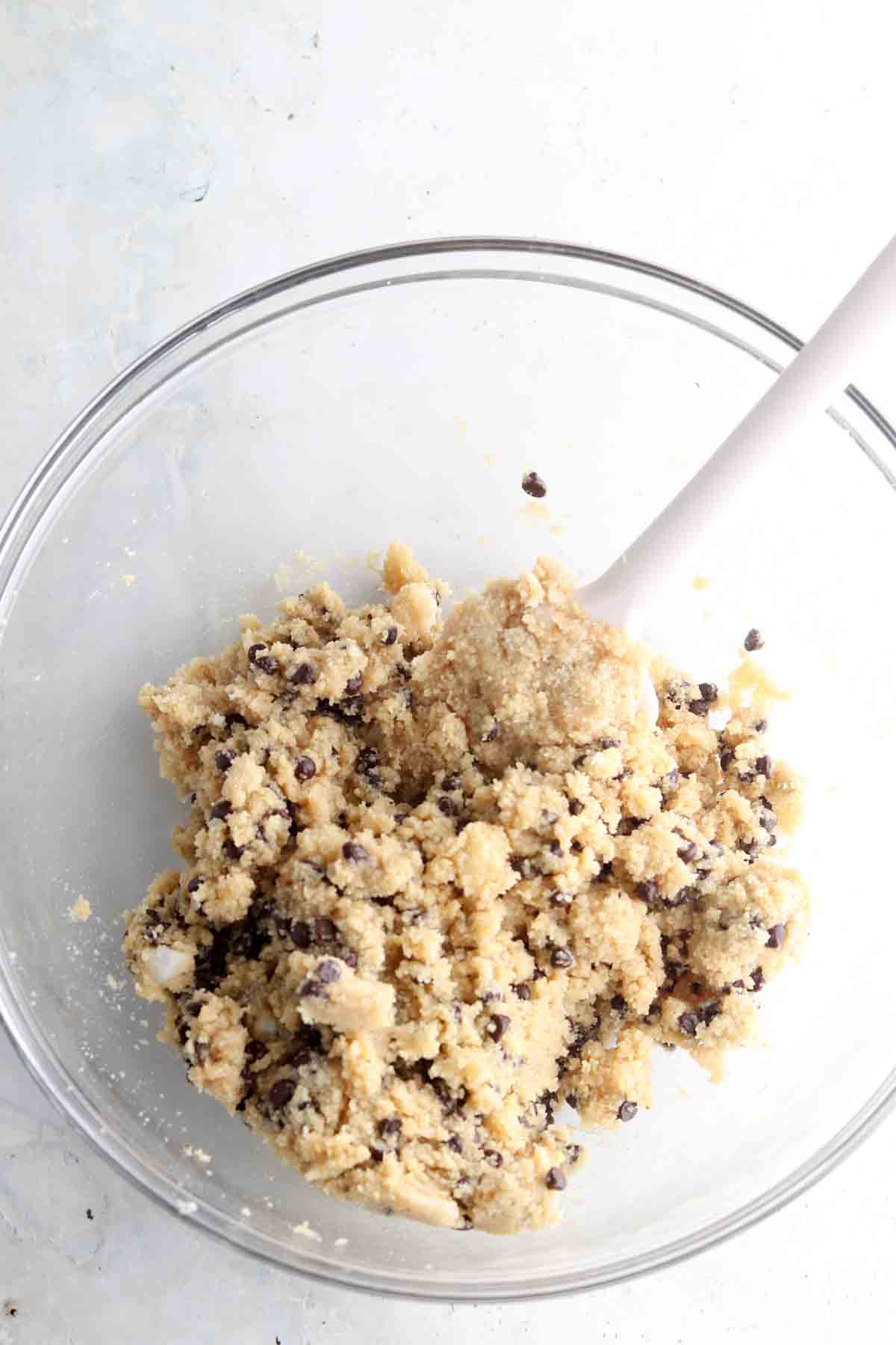 Cookie dough well mixed in a large glass bowl. 