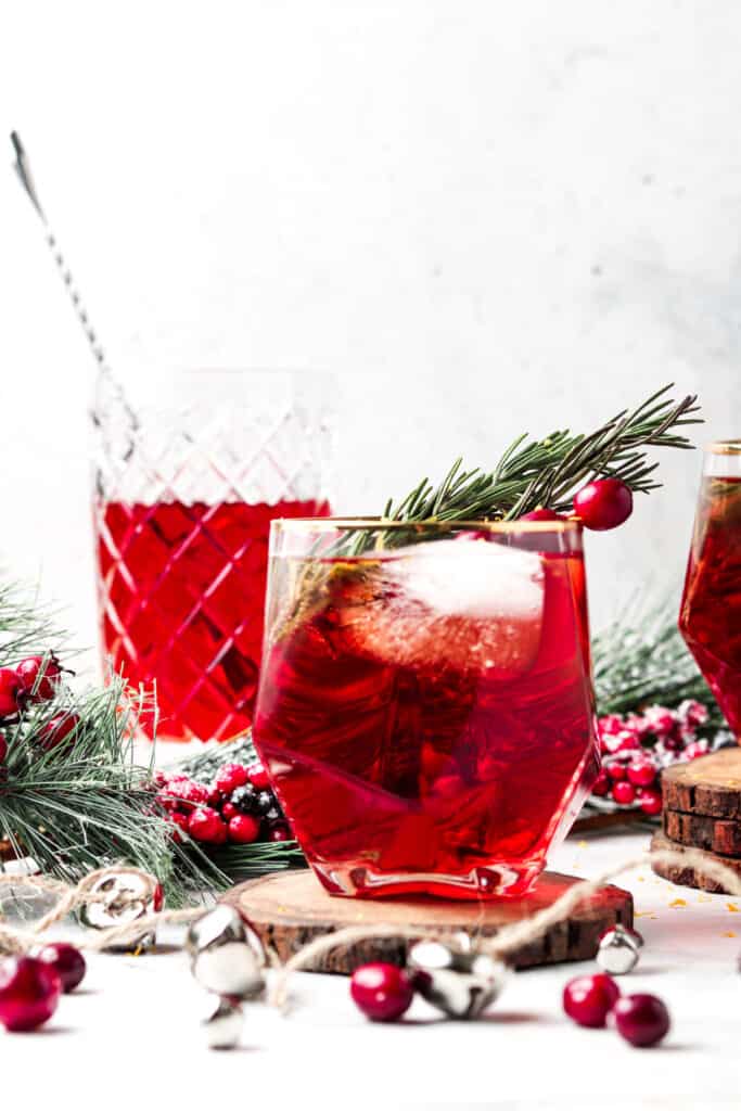 cranberry mocktail with fresh rosemary in a cocktail glass with Christmas decorations 