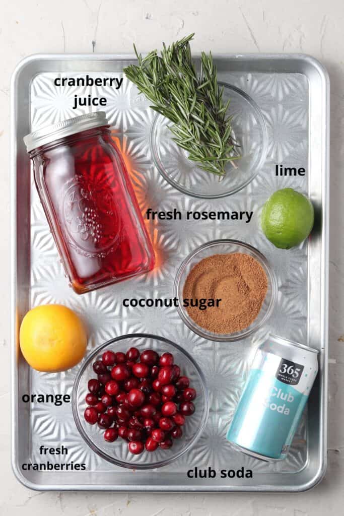 cranberry mocktail ingredients on a silver tray