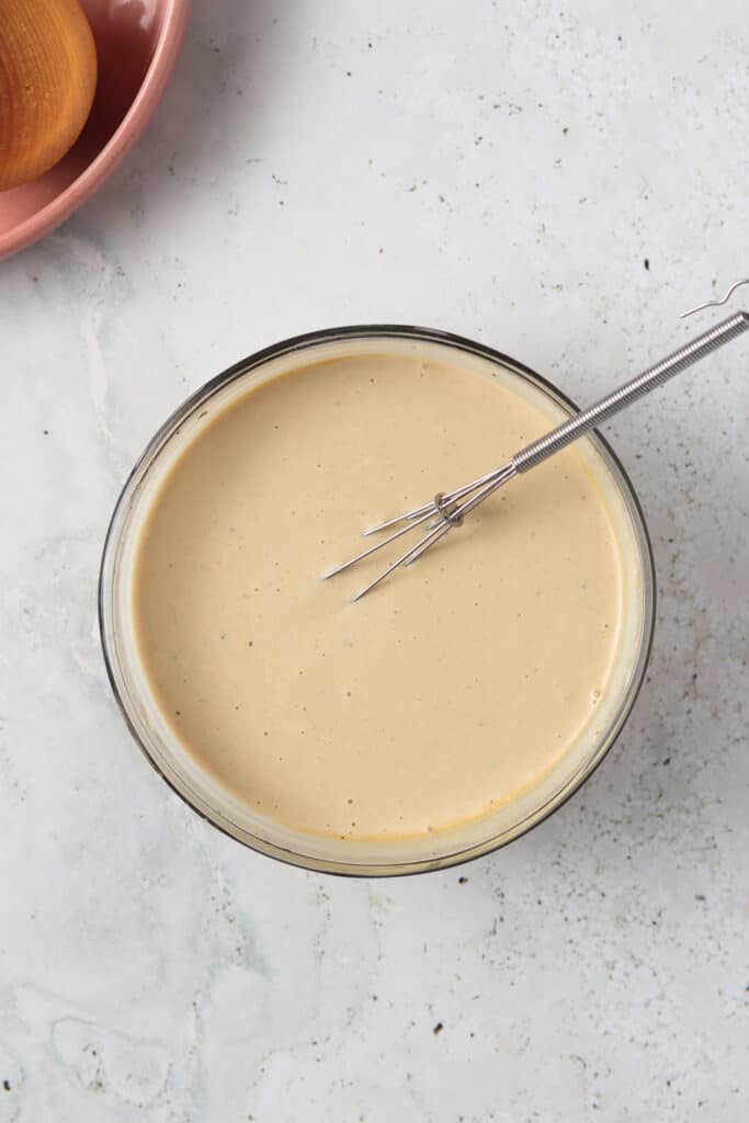 whole30 caesar dressing mixing in a bowl with a whisk