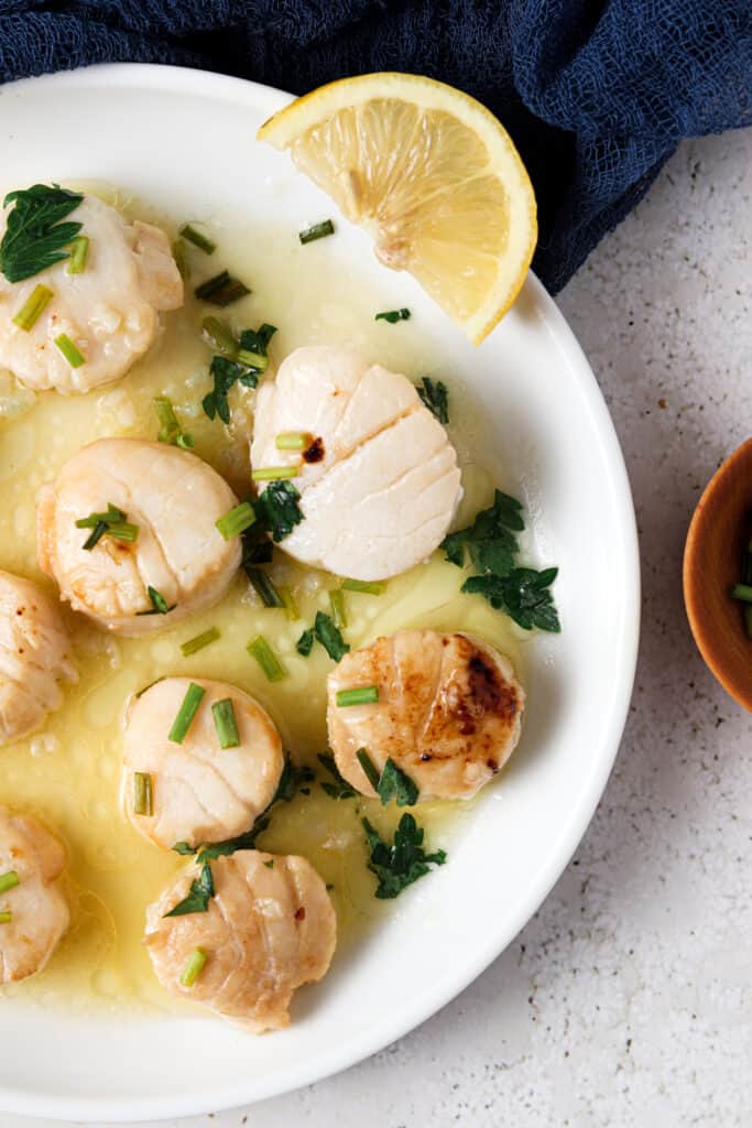 overhead shot of whole30 scallops on a white plate