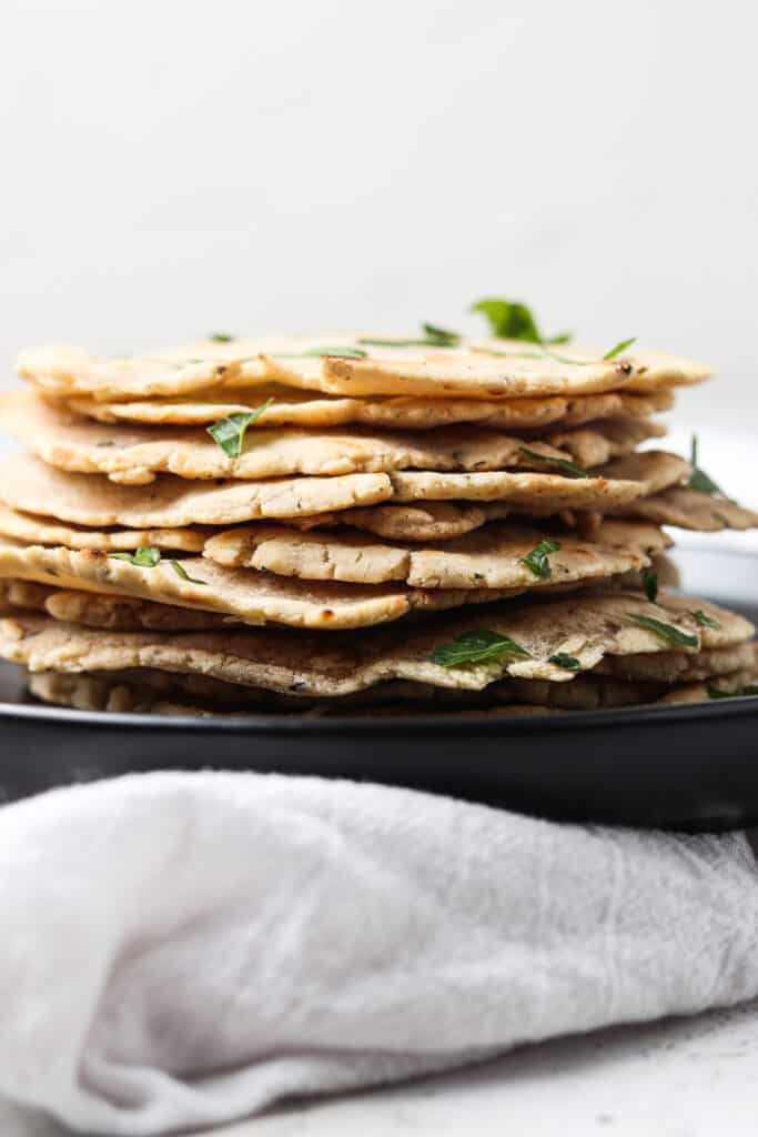 aip tortillas stacked on a black plate